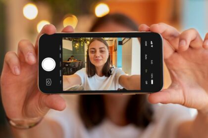 caucasian woman taking selfie with her smartphone