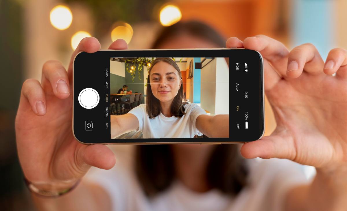 caucasian woman taking selfie with her smartphone