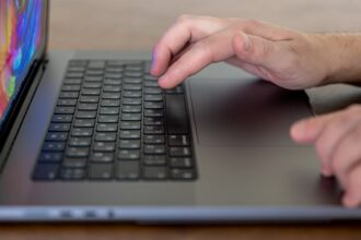 closeup male hands are typing keys laptop