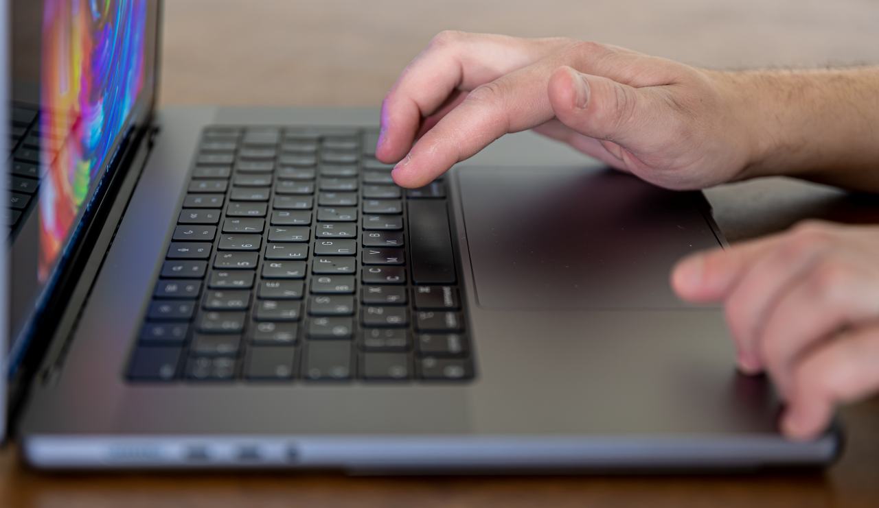 closeup male hands are typing keys laptop